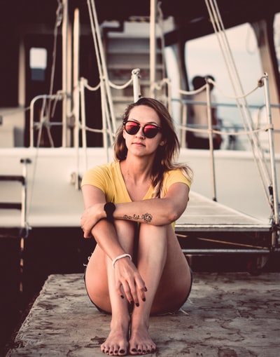 The woman sitting next to the ship
